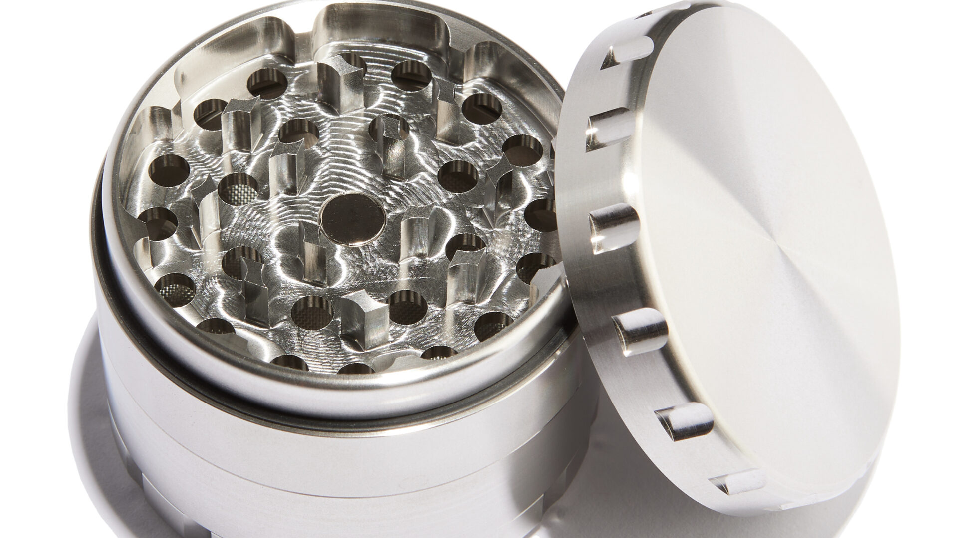 Blick in das offene Mahlwerk des Edelstahl Grinders mit messerscharfen, CNC-gefrästen Zähnen und Magnetverschluss.